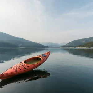 Sunset over a lake with a capsized kayak