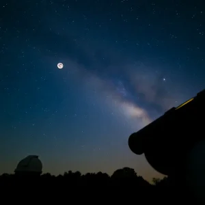 A telescope under a starry sky for an astronomy event