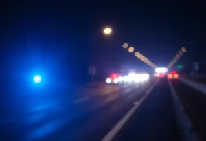 Highway scene with police lights representing a gun violence incident